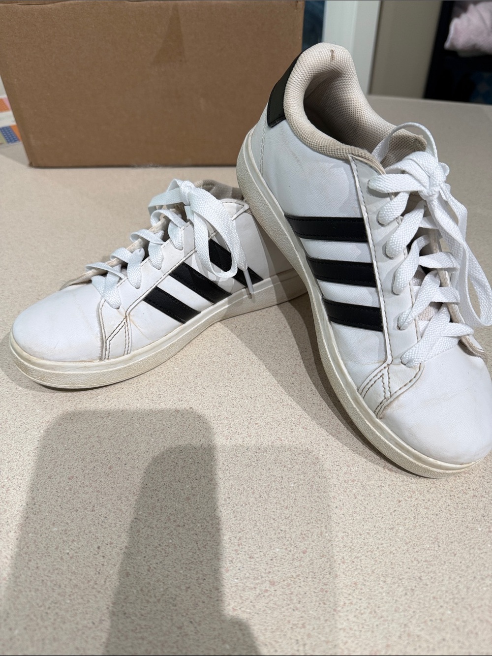 White and black size 3 Adidas sneakers